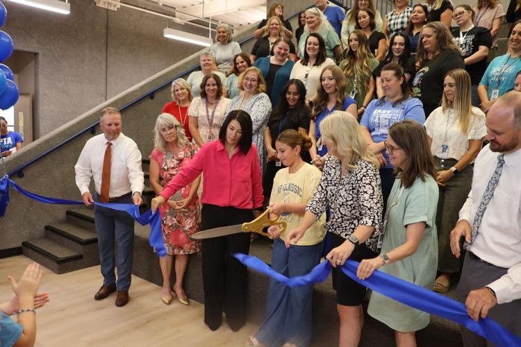Ribbon cutting with Iron County School District staff and students at a new school opening.